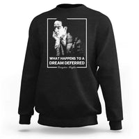 Black crewneck sweatshirt with front portrait graphic and quote text