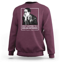 Maroon crewneck sweatshirt with front portrait graphic and quote text