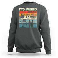 Dark heather crewneck sweatshirt with retro beach quote graphic on back