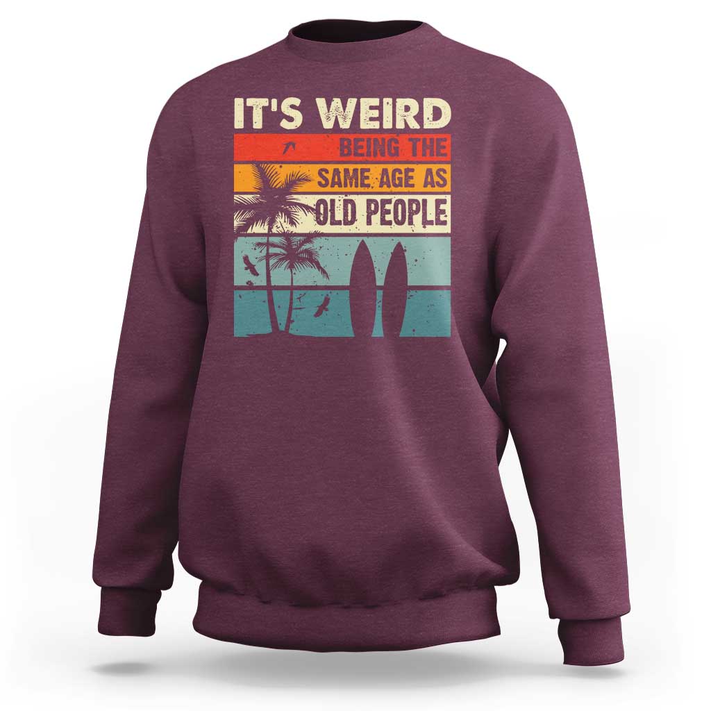 Maroon crewneck sweatshirt with retro beach quote graphic on back