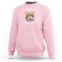 Light pink crewneck sweatshirt with cat meme graphic reading “WAKE UP ACT SILLY”.
