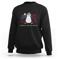 Black crewneck sweatshirt with penguin and U.S. flag graphic, “FIGHT OR FLIGHT” text.