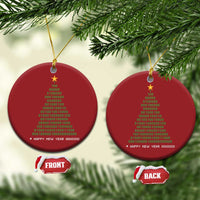 Two red round Christmas ornaments with gold star and binary “Happy New Year” text on cords.