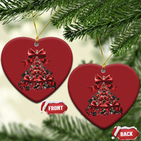 Two red heart-shaped Christmas tree ornaments hanging on gold strings, front and back shown