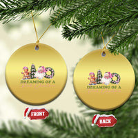 Pair of gold circle ornaments on tree branches, each with pink holiday character graphic