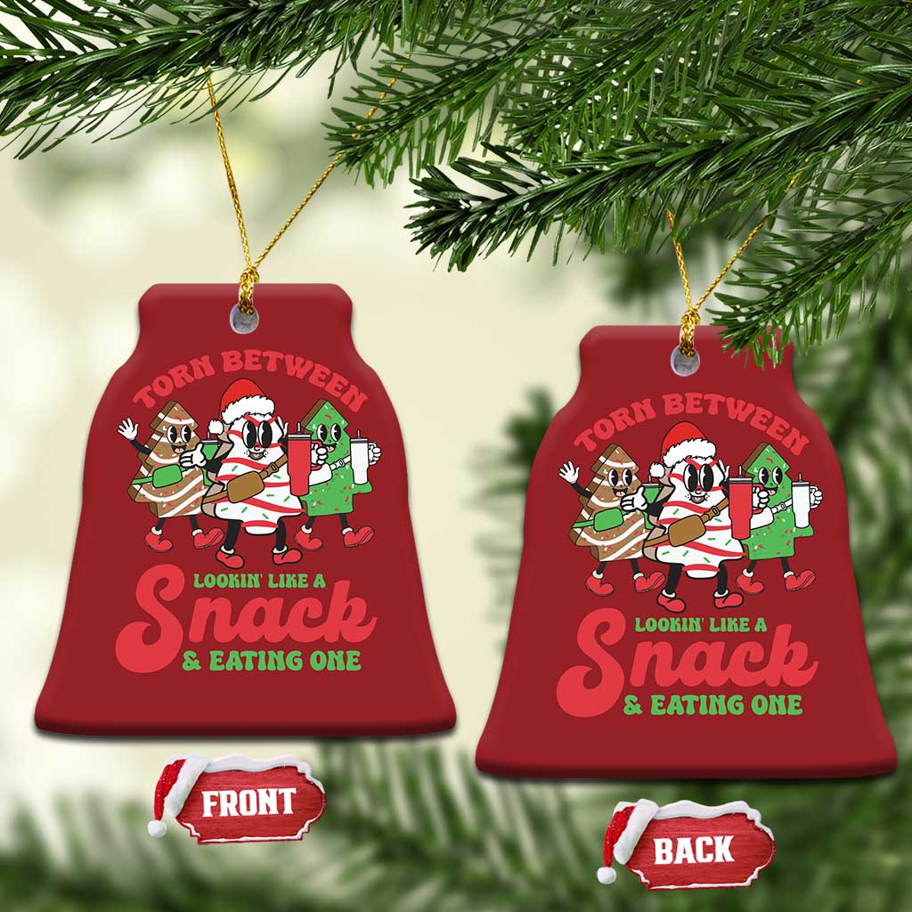 Red bell-shaped Christmas ornament with cartoon “Torn Between” snack design, front and back