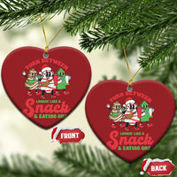 Two red heart-shaped Christmas ornaments with cartoon “Torn Between” snack design and gold loops