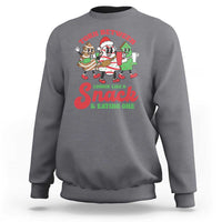 Charcoal gray Christmas cake sweatshirt with large chest graphic reading “Lookin like Snack & eating one”.