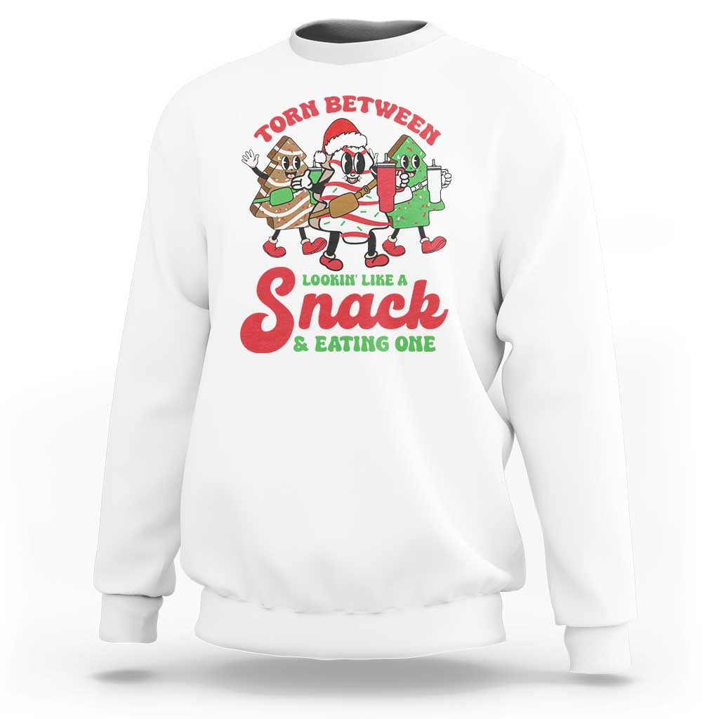White Christmas cake sweatshirt with large chest graphic reading “Lookin like Snack & eating one”.