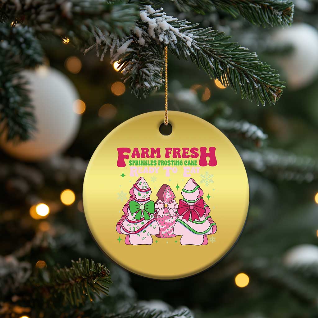 Gold round Christmas ornament hanging on a tree branch with Farm Fresh holiday graphic