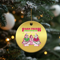 Gold round Christmas ornament hanging on a tree branch with Farm Fresh holiday graphic