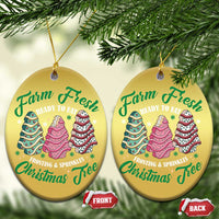 Two gold round Christmas ornaments with cake tree graphics and gold hanging loops