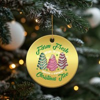 Gold round Christmas ornament with cake tree graphic and gold hanging loop
