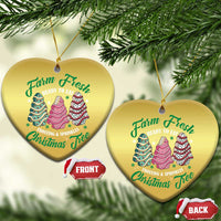 Two gold heart Christmas ornaments with cake tree graphic and gold hanging loops