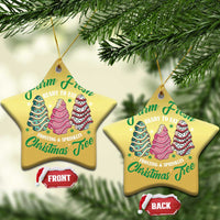 Two gold star-shaped Christmas ornaments with cake tree graphics and gold hanging loops