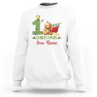 White baby Christmas sweatshirt with gingerbread teddy, tree graphic, and "Your Name" text