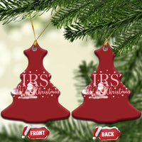 Two red tree-shaped “My FIRST Christmas” ornaments hanging from gold cords