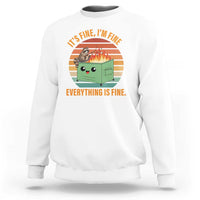 White sweatshirt with 'Everything is fine' raccoon graphic