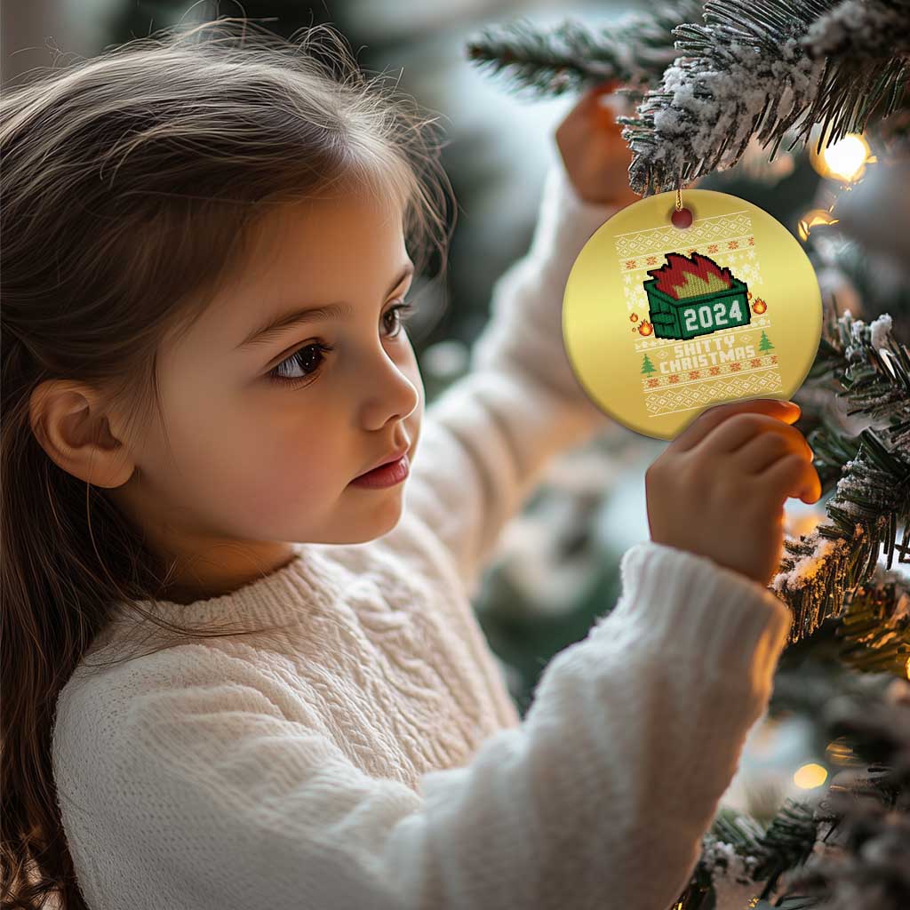 Gold round ornament on tree, with 2024 fire graphic and festive text