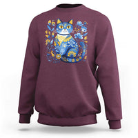 Maroon sweatshirt with blue floral cat graphic on the chest