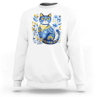 White sweatshirt with blue floral cat graphic on the chest