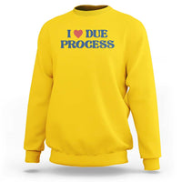 Yellow crewneck sweatshirt with Due Process heart logo on chest