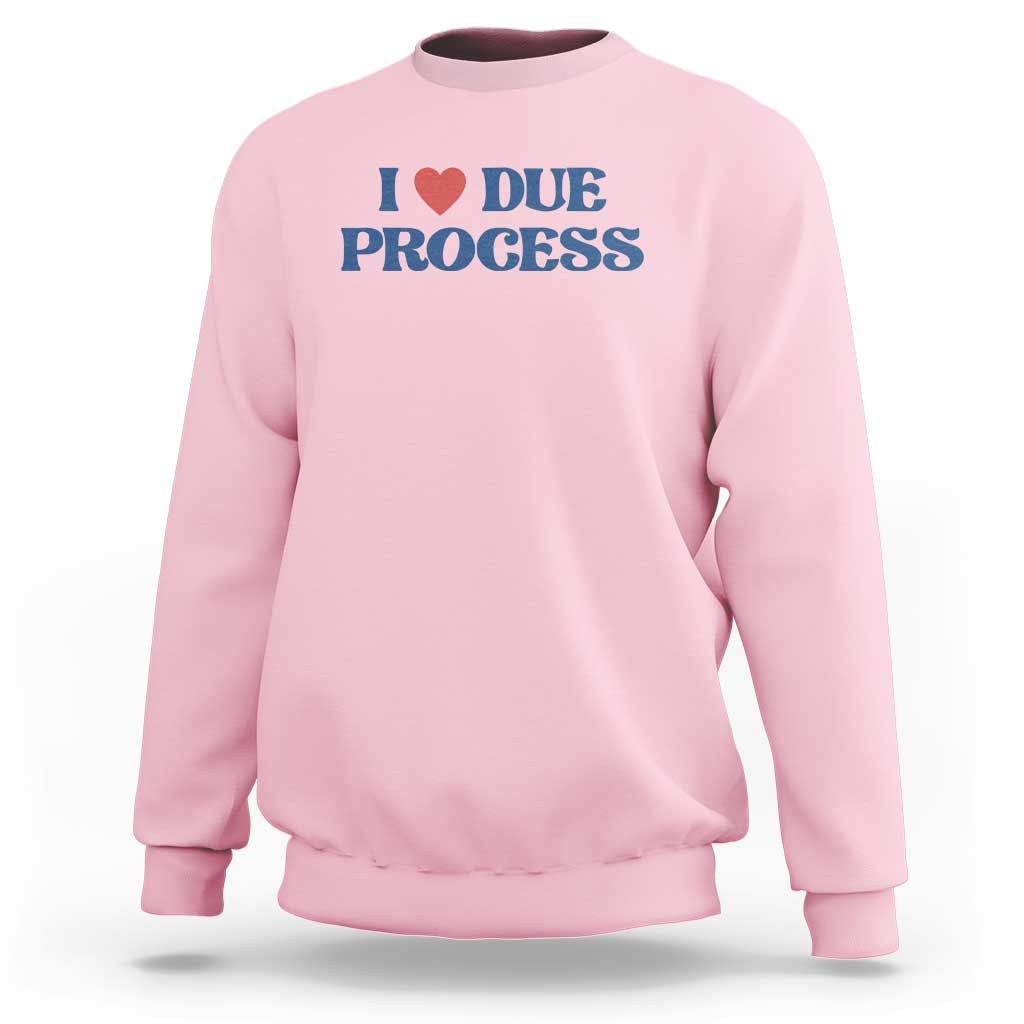 Light pink crewneck sweatshirt with Due Process heart logo on chest