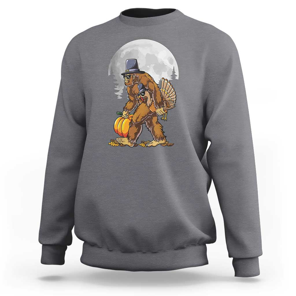 Charcoal gray crewneck sweatshirt with pilgrim-style Bigfoot graphic holding a turkey