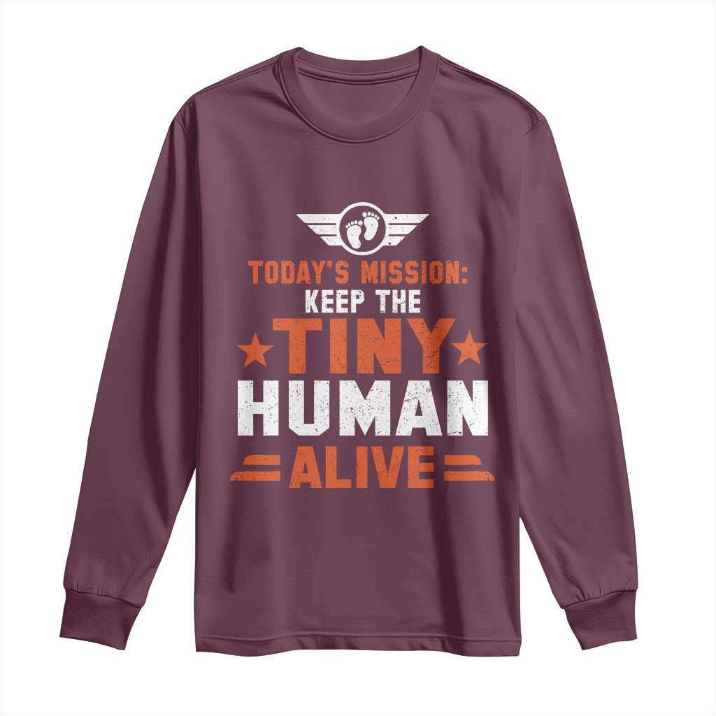 Maroon long-sleeve shirt with “Today’s Mission: Keep the Tiny Human Alive” graphic
