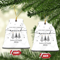 Two white marble bell-shaped ornaments, 'Our First Christmas married James & Emily 2024'.