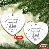 Two white marble heart ornaments with 'Our First Christmas married James & Emily 2024'.