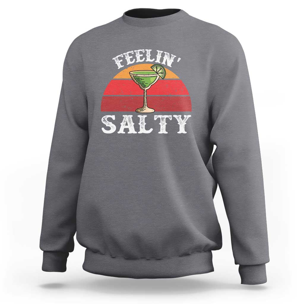 Charcoal crewneck sweatshirt with “FEELIN’ SALTY” margarita graphic on front