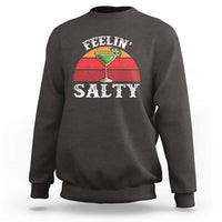Dark chocolate crewneck sweatshirt with “FEELIN’ SALTY” margarita graphic on front