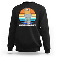 Black crewneck sweatshirt with capybara graphic and “DON’T BE WORRY BE CAPY” text
