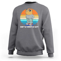 Charcoal gray crewneck sweatshirt with capybara graphic and “DON’T BE WORRY BE CAPY” text