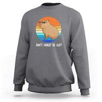Dark heather gray capybara graphic sweatshirt with 'DON'T WORRY BE CAPY' front print