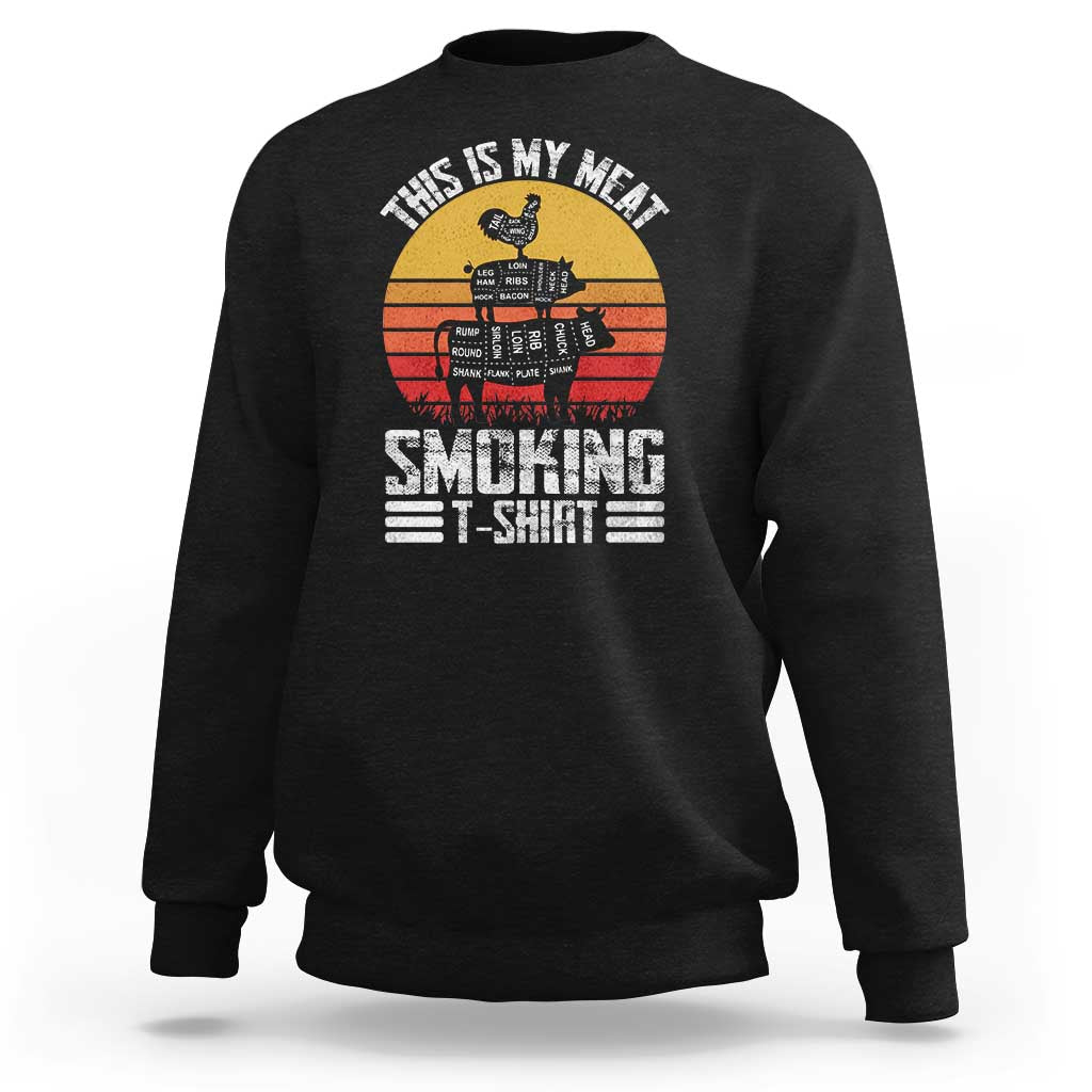 Black crewneck sweatshirt with BBQ smoker graphic and “Smoking” text on front