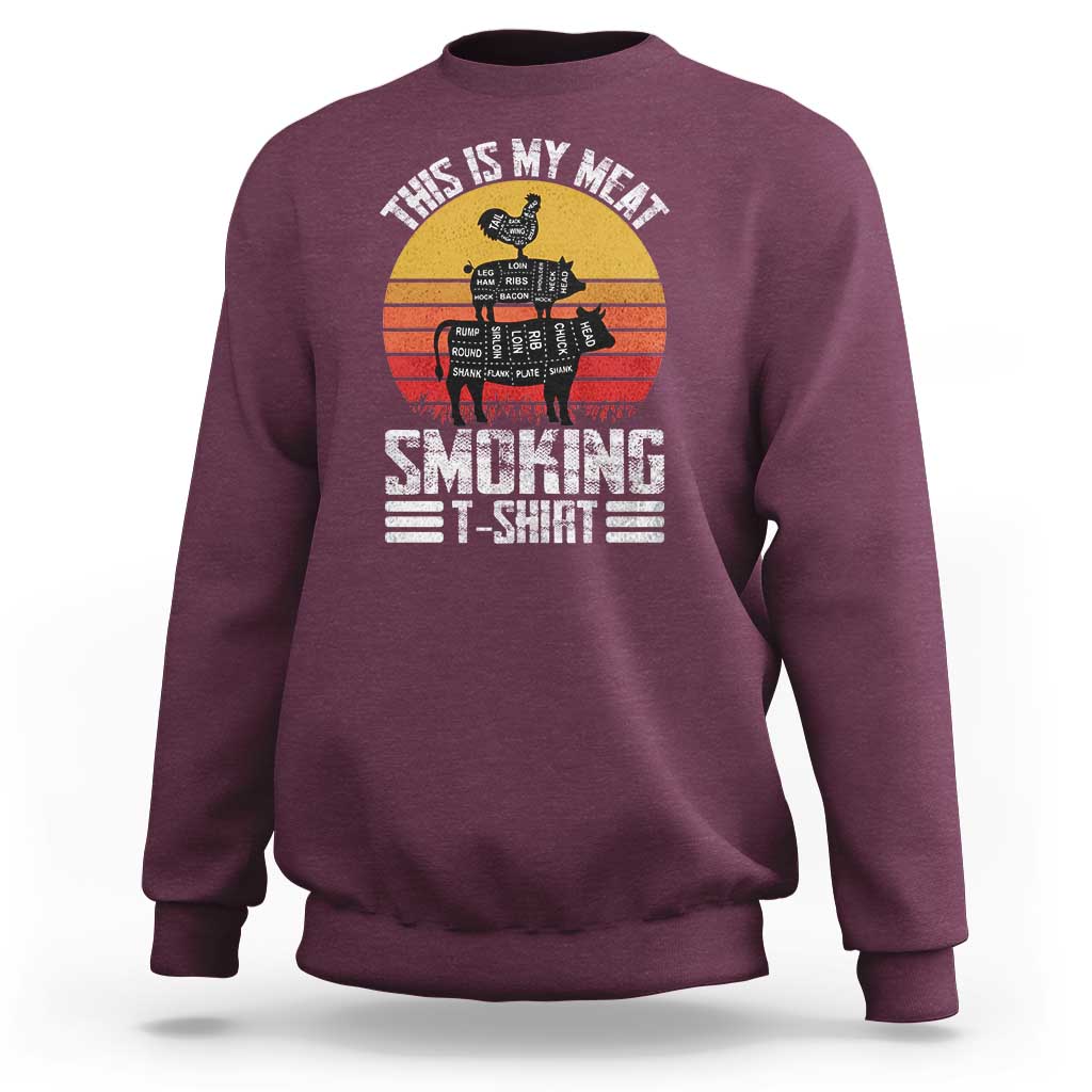 Maroon crewneck sweatshirt with BBQ smoker graphic and “Smoking” text on front