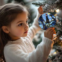 Child holding a personalized cat memorial round Christmas ornament in blue with black cat