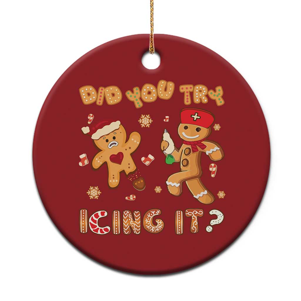 Red round Christmas ornament with nurse and gingerbread figures; “Did you try icing it?”