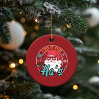 Red round Christmas ornament with Santa portrait and 'I Do It For the Ho's' lettering
