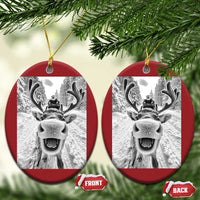 Red oval Christmas ornament with hanging loop and selfie-style reindeer photo graphic