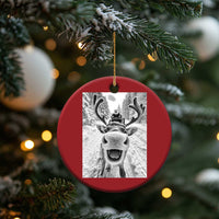 Red round Christmas ornament with hanging loop and selfie-style reindeer photo graphic