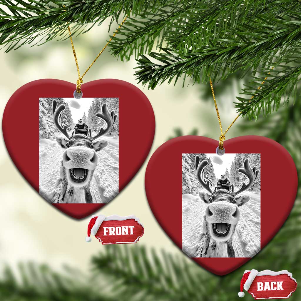 Red heart-shaped Christmas ornament with selfie-style reindeer graphic and hanging loop
