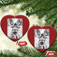 Red heart-shaped Christmas ornament with selfie-style reindeer graphic and hanging loop