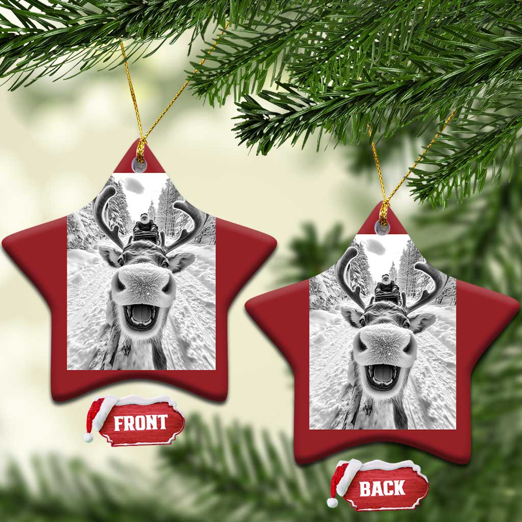 Red star-shaped Christmas ornament with hanging loop and selfie-style reindeer photo graphic
