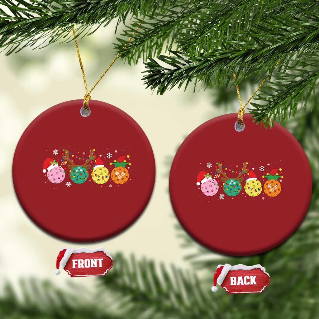 Two red round pickleball Christmas ornaments with colorful ball graphic and hanging gold strings
