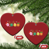 Red heart-shaped pickleball Christmas ornament with colorful ball graphic and gold hanging loop