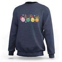 Navy crewneck sweatshirt with long sleeves and colorful pickleball Christmas graphic