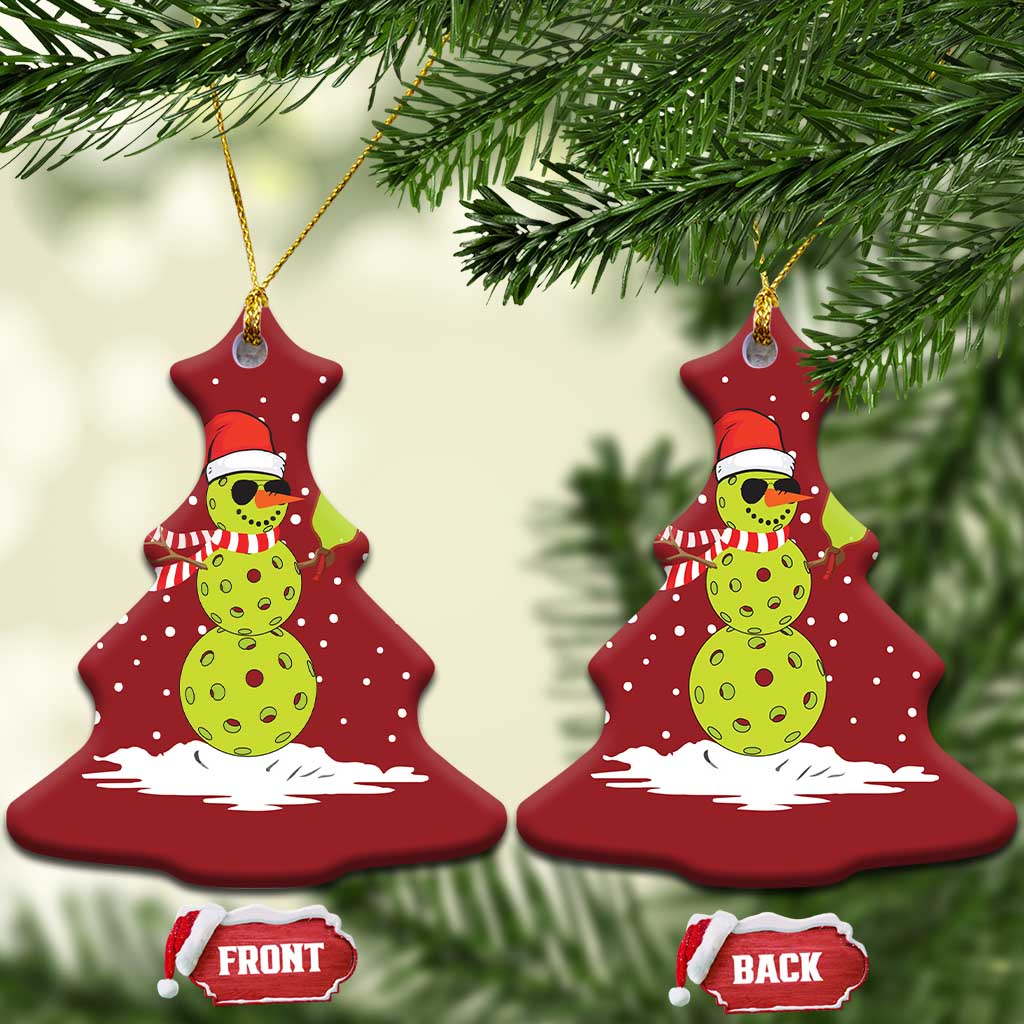 Two red Christmas tree-shaped ornaments with cartoon snowman holding a paddle, gold hooks